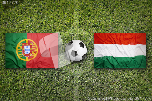 Image of Portugal vs. Hungary flags on soccer field