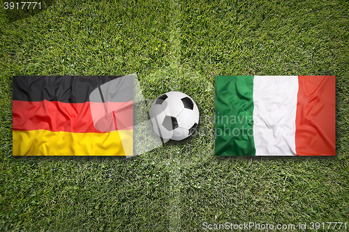 Image of Germany vs. Italy flags on soccer field