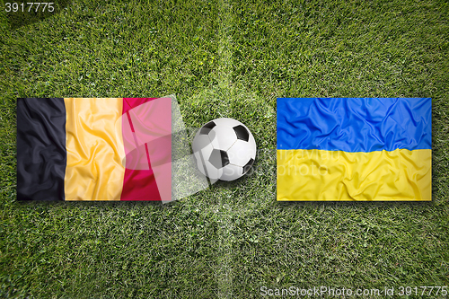 Image of Belgium vs. Ukraine flags on soccer field