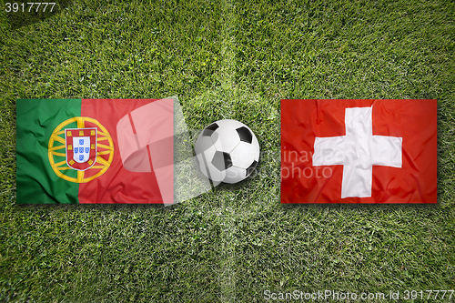 Image of Portugal vs. Switzerland flags on soccer field