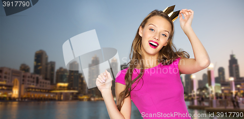 Image of happy young woman or teen girl in pink dress