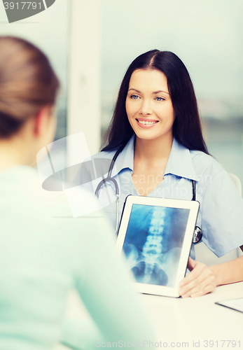 Image of doctor or nurse showing x-ray with tablet pc