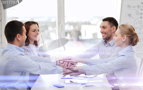 Image of business team celebrating victory in office