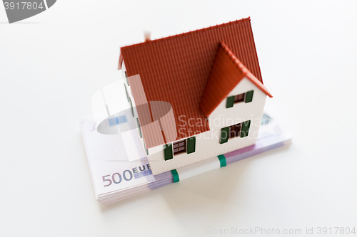 Image of close up of home or house model and money