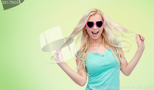 Image of happy young blonde woman or teenager in sunglasses
