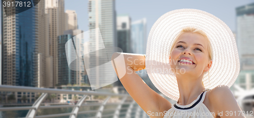 Image of happy woman enjoying summer over dubai city