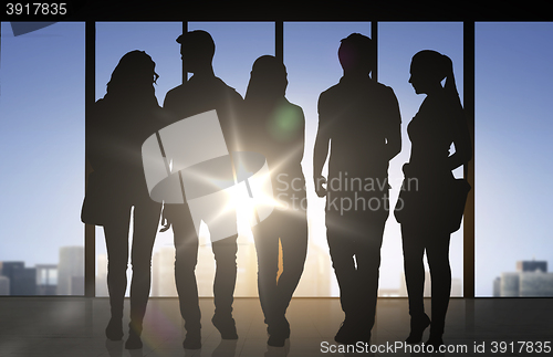 Image of people silhouettes over office background