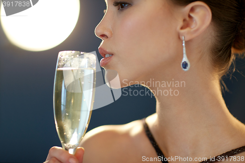 Image of close up of woman drinking champagne at party