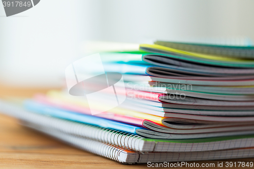 Image of close up of notebooks on wooden table