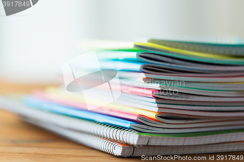 Image of close up of notebooks on wooden table