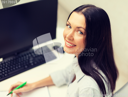 Image of smiling businesswoman or student studying