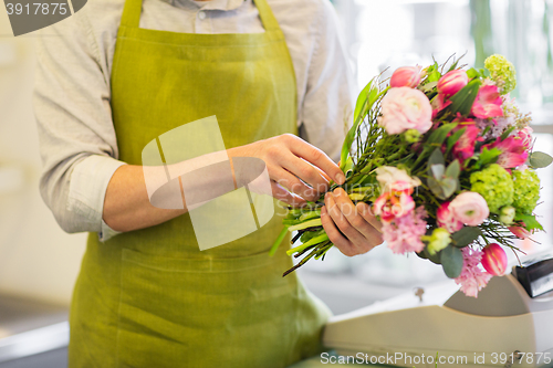 Image of close up of man making bunch at flower shop