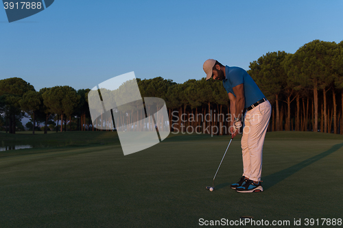 Image of golfer  hitting shot at golf course