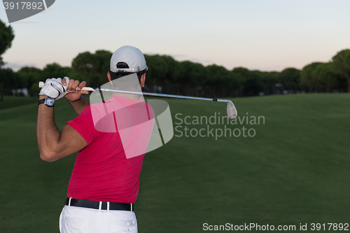 Image of golfer hitting a sand bunker shot on sunset