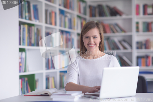 Image of female student study in school library