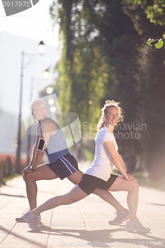 Image of couple warming up and stretching before jogging