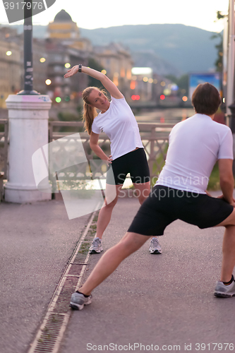 Image of couple warming up before jogging