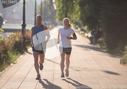 Image of couple warming up and stretching before jogging