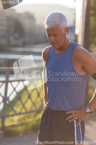 Image of portrait of handsome senior jogging man