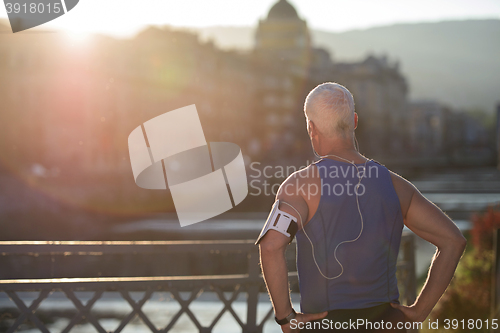 Image of portrait of handsome senior jogging man