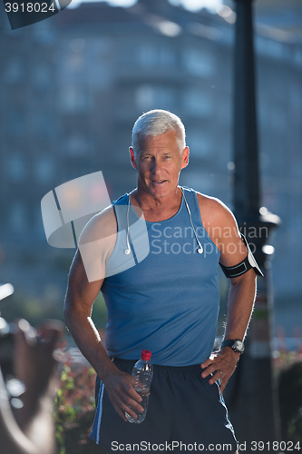 Image of portrait of handsome senior jogging man