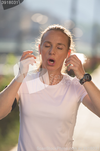 Image of jogging woman setting phone before jogging