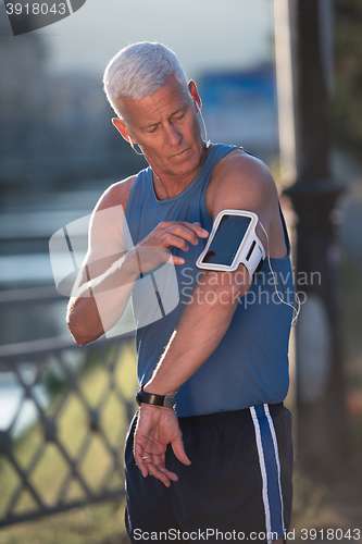 Image of portrait of handsome senior jogging man