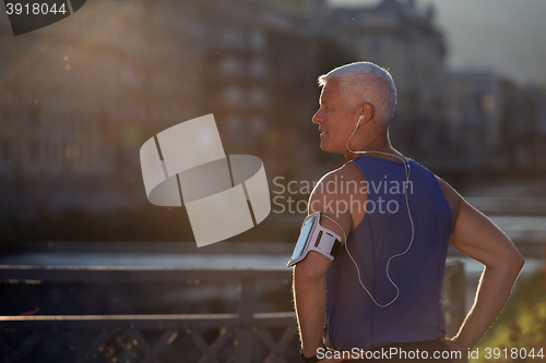 Image of portrait of handsome senior jogging man