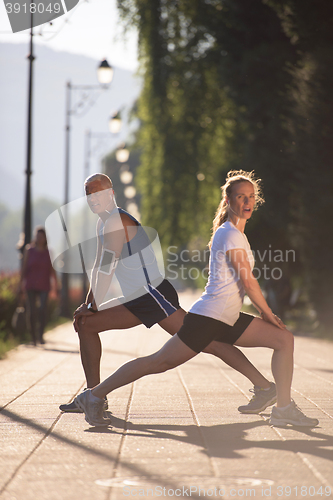 Image of couple warming up and stretching before jogging