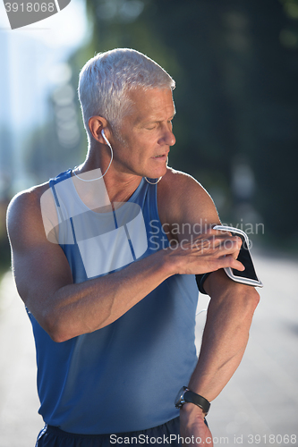 Image of portrait of handsome senior jogging man