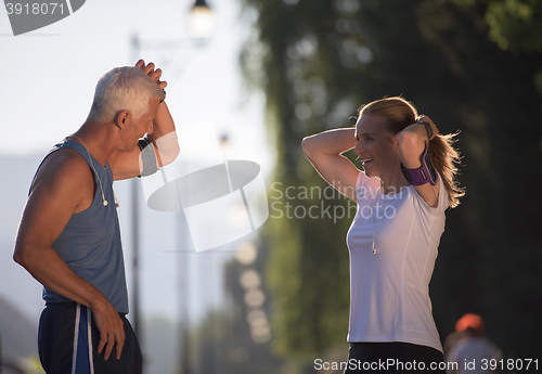 Image of jogging couple planning running route  and setting music