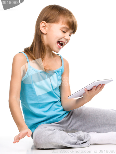 Image of Young girl is using tablet