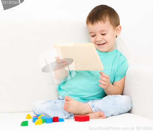 Image of Boy is playing with puzzle