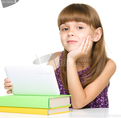 Image of Young girl is using tablet