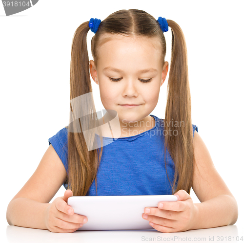 Image of Young girl is using tablet