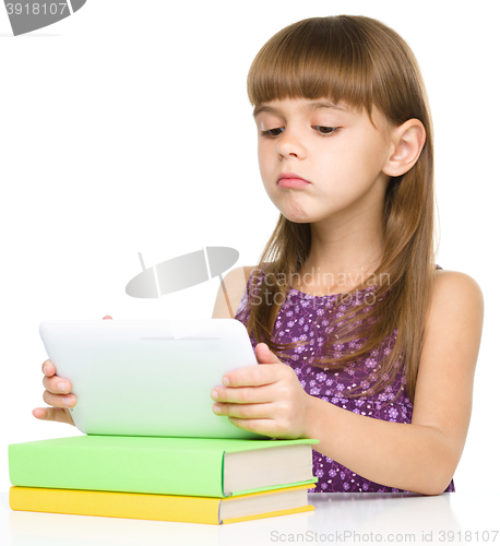 Image of Young girl is using tablet