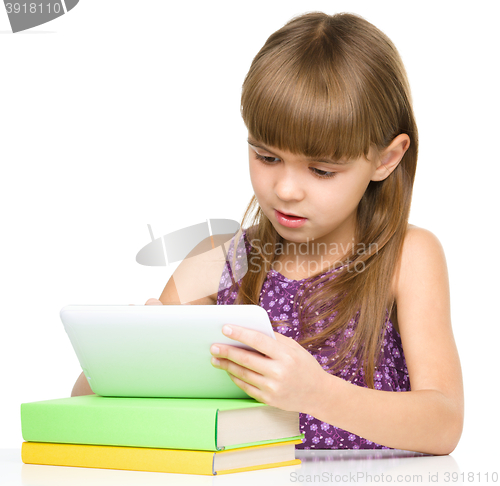 Image of Young girl is using tablet