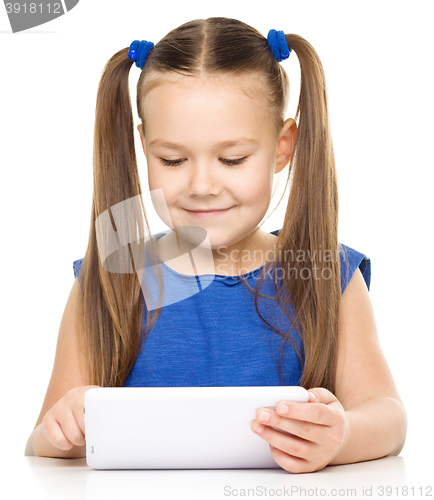 Image of Young girl is using tablet