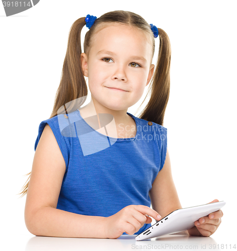 Image of Young girl is using tablet