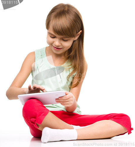 Image of Young girl is using tablet