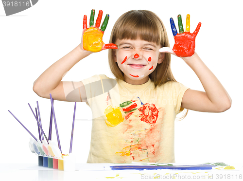 Image of Portrait of a cute girl playing with paints