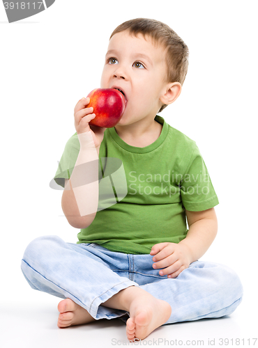 Image of Portrait of a cute little boy with red apple