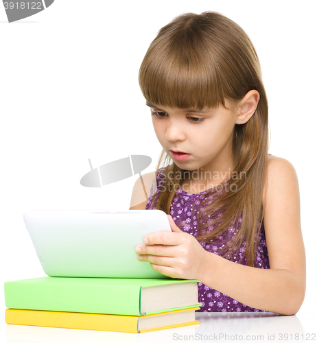 Image of Young girl is using tablet