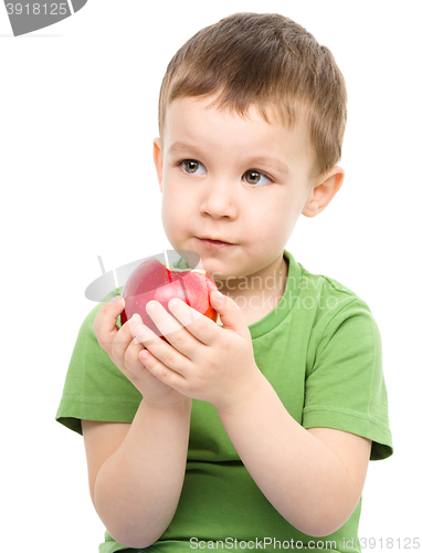 Image of Portrait of a cute little boy with red apple