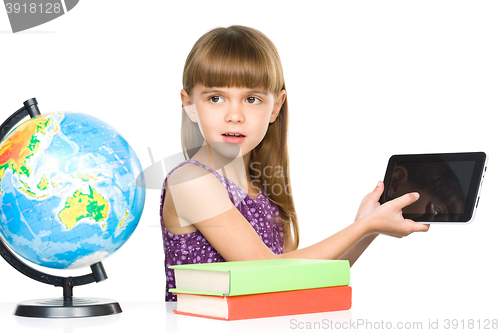 Image of Young girl is showing tablet