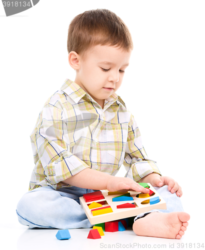 Image of Little boy is playing with toys