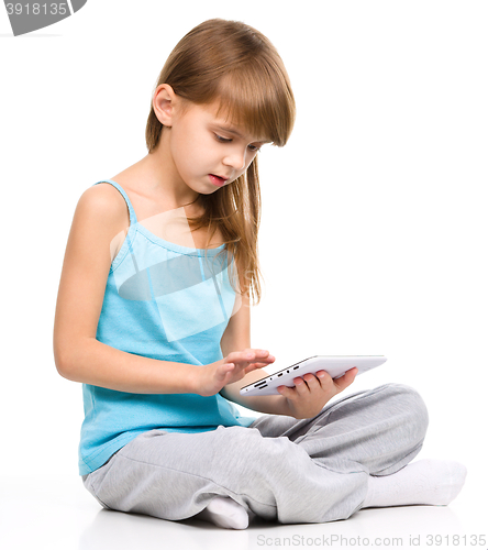 Image of Young girl is using tablet