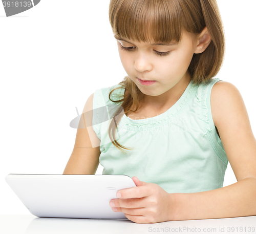 Image of Young girl is using tablet