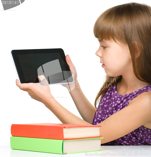 Image of Young girl is showing tablet