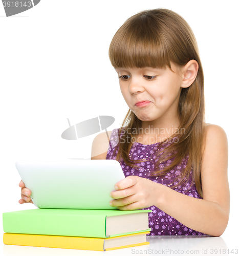 Image of Young girl is using tablet